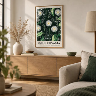 Yayoi Kusama Dandelions: Dark Green Wall Art, framed on the wall of a calm Japandi living room with a warm white wall