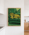 Line-drawn lion poster with curled body on sofa, textured upholstery, and foliage outside the window