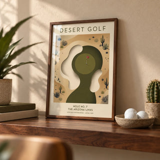 Desert Golf Print, a small A4 framed print leaning on a walnut shelf in a living room