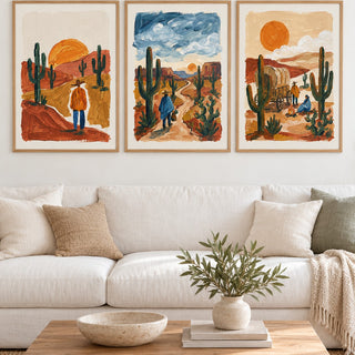 Desert Wall Art hung at eye level above a white linen sofa: Desert Sunset Print, Desert Walk and Desert Wagon shown framed side by side (frames not included)
