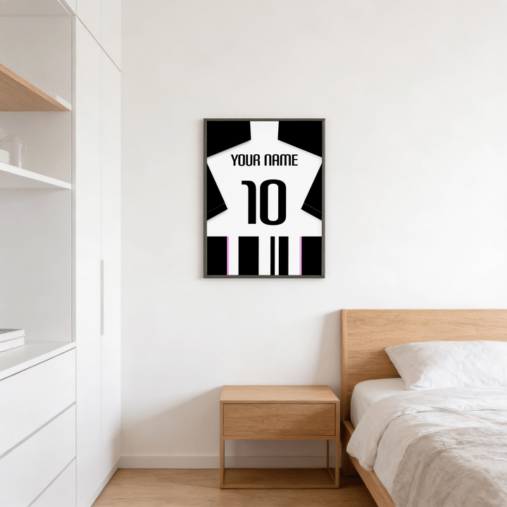 Football Shirt Poster in Black and White Stripes with Pink Accents on a bedroom wall above a wooden bedside table