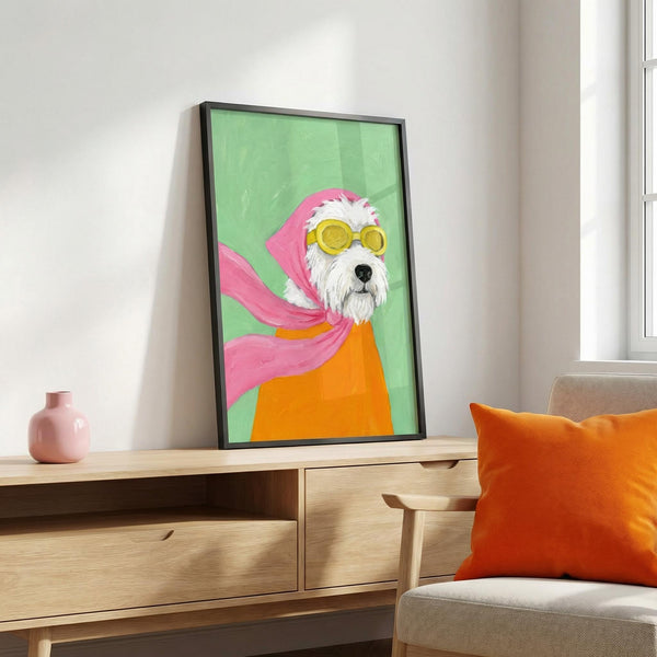 Framed artwork of a dog wearing sunglasses and a pink hood on a wooden cabinet with an orange pillow.