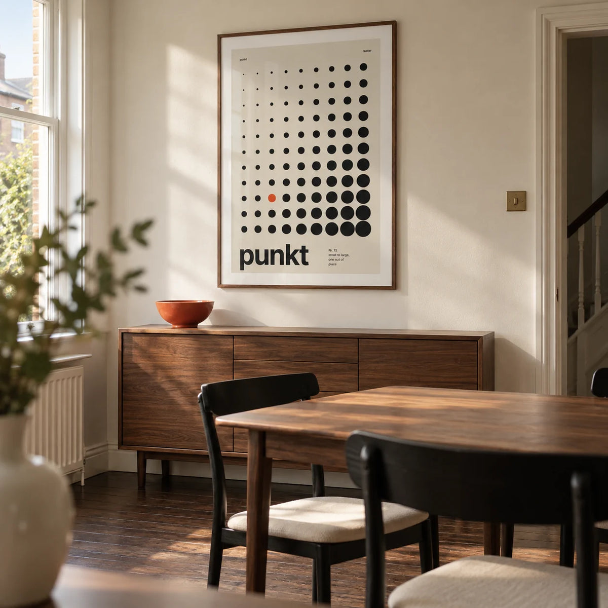 Dots Print, framed on the wall of a modern dining room in a UK terraced house with a cream wall and dark timber floor