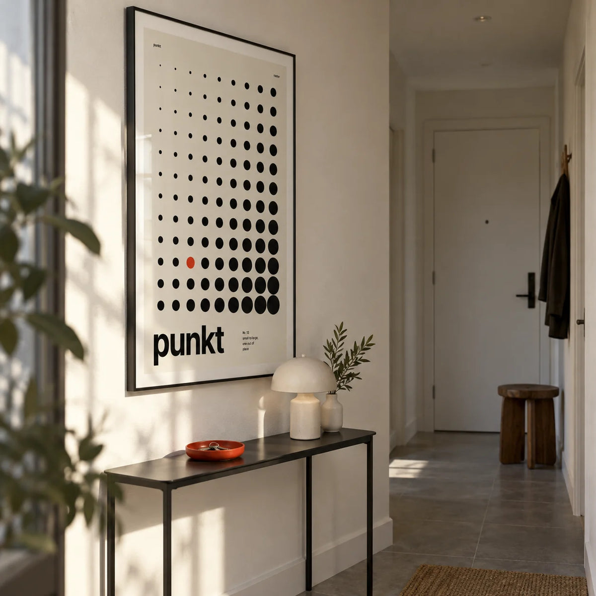 Dots Print, framed on the wall of a narrow entrance hall in a contemporary UK flat with warm white walls and a plain grey stone floor