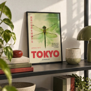 Dragonfly Wall Art, a small A4 framed print leaning on a black metal shelf in a living room
