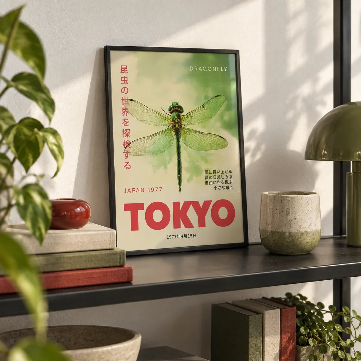 Dragonfly Wall Art, a small A4 framed print leaning on a black metal shelf in a living room