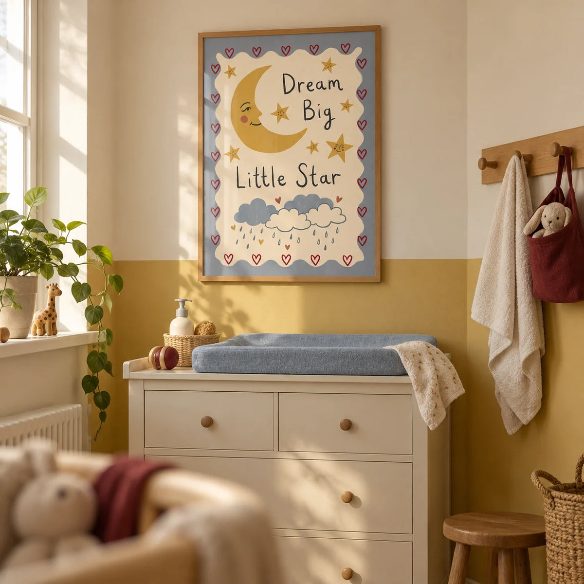 Dream Big Poster, framed on the wall of a compact nursery changing corner in a UK flat with a muted mustard yellow lower wall and cream upper wall
