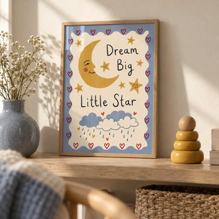 Dream Big Poster, a small A4 framed print leaning on a pale oak shelf in a living room