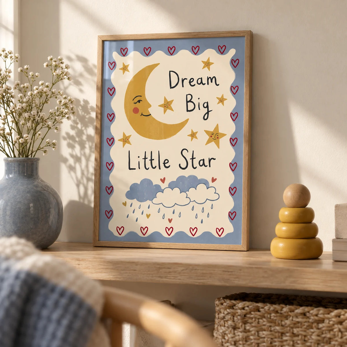 Dream Big Poster, a small A4 framed print leaning on a pale oak shelf in a living room