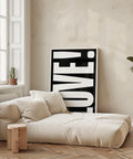 LOVE poster displayed in a sleek, modern room setting.