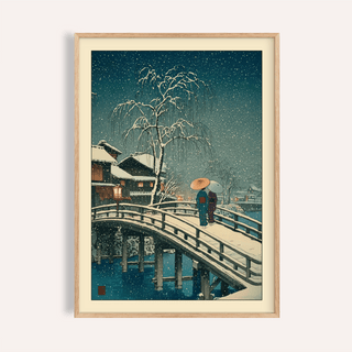 Overhead view of framed Hasui Kawase snow print on a studio table