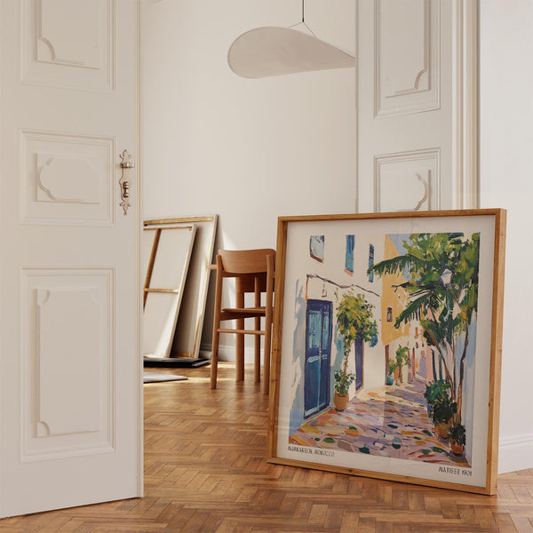 Painterly Moroccan alley with sunlit paths and blue shutters.