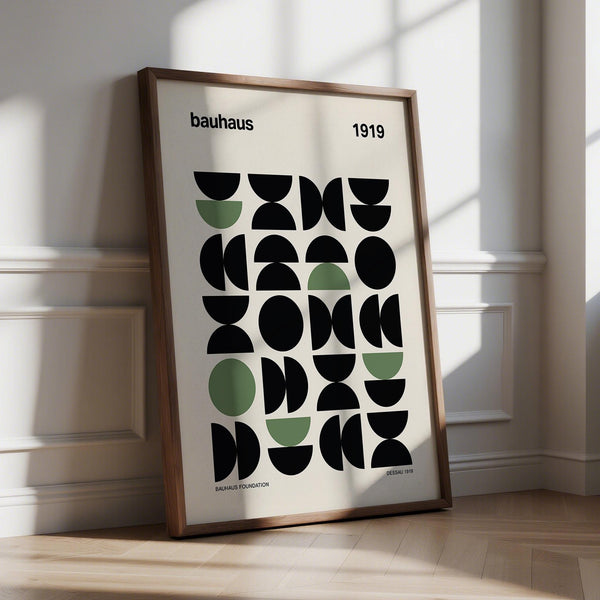 Gallery print with bold black and green geometric Bauhaus shapes on cream background.