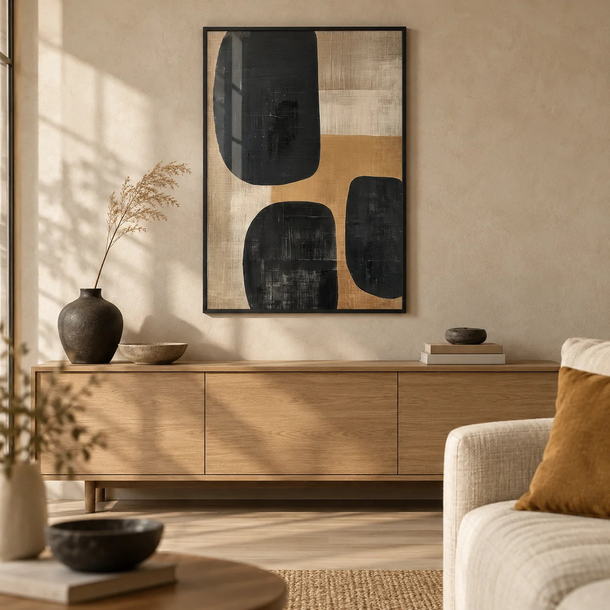 Earthy abstract art print leaning beside a sofa