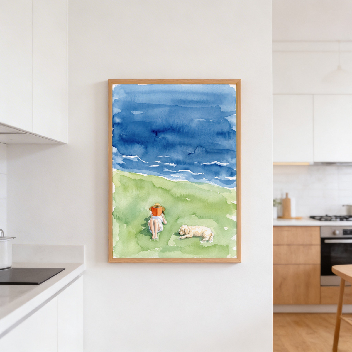 Seaside scene wall art print focused on the lounging dog and the reader holding an open book