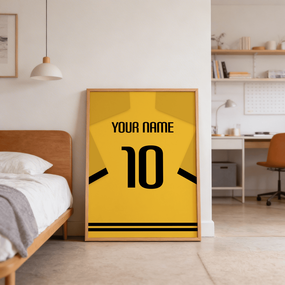 Close-up of block lettering and stripe accents on yellow football shirt graphic