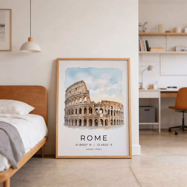 Print leaning on the floor showing Rome Colosseum art print in light brown frame beside a bed in a bedroom