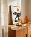 Minimalist tiger wall art print showing stripes, walking pose, and orange circle