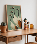 Framed crane illustration print styled above modern console table