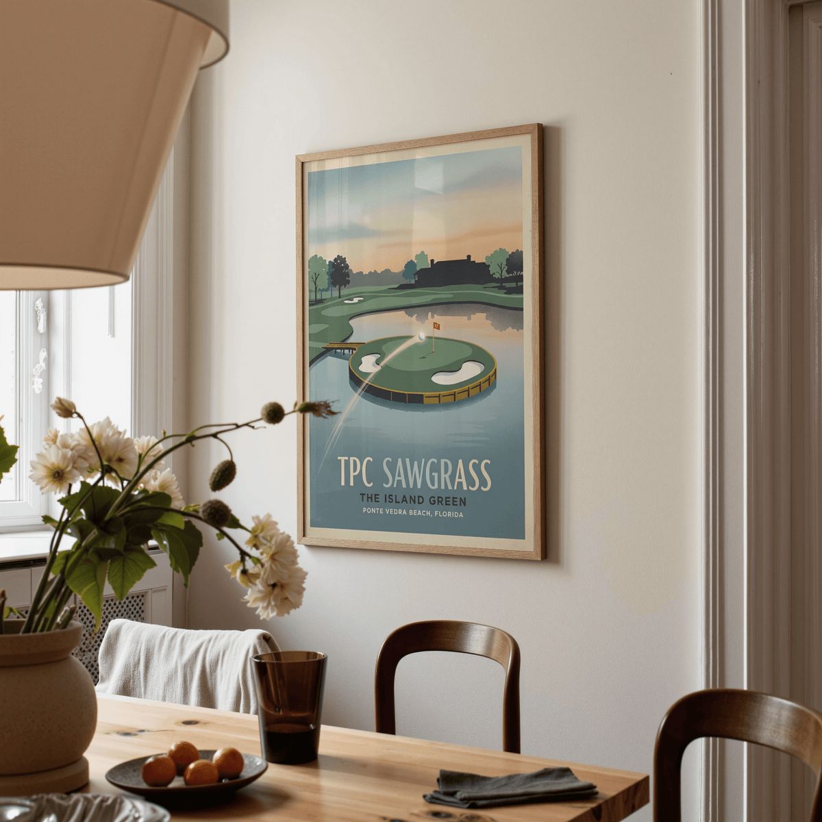 Graphic wall art print showing a golf ball flight path toward the island green and flagstick