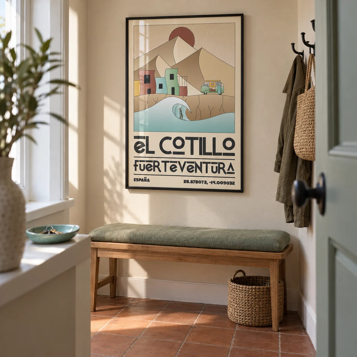 El Cotillo Surfing Poster, framed on the wall of a compact entrance hallway in a renovated UK terrace with a sand beige wall and plain terracotta floor tiles
