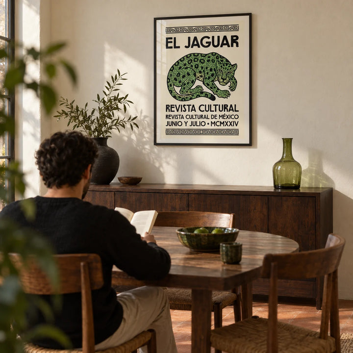 El Jaguar Poster, framed on the wall of a dining room with a cream plaster wall and a plain terracotta floor
