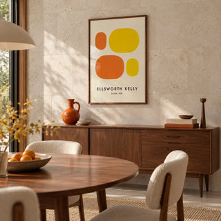 Ellsworth Kelly Prints, framed on the wall of a mid-century dining room with a pale stone wall