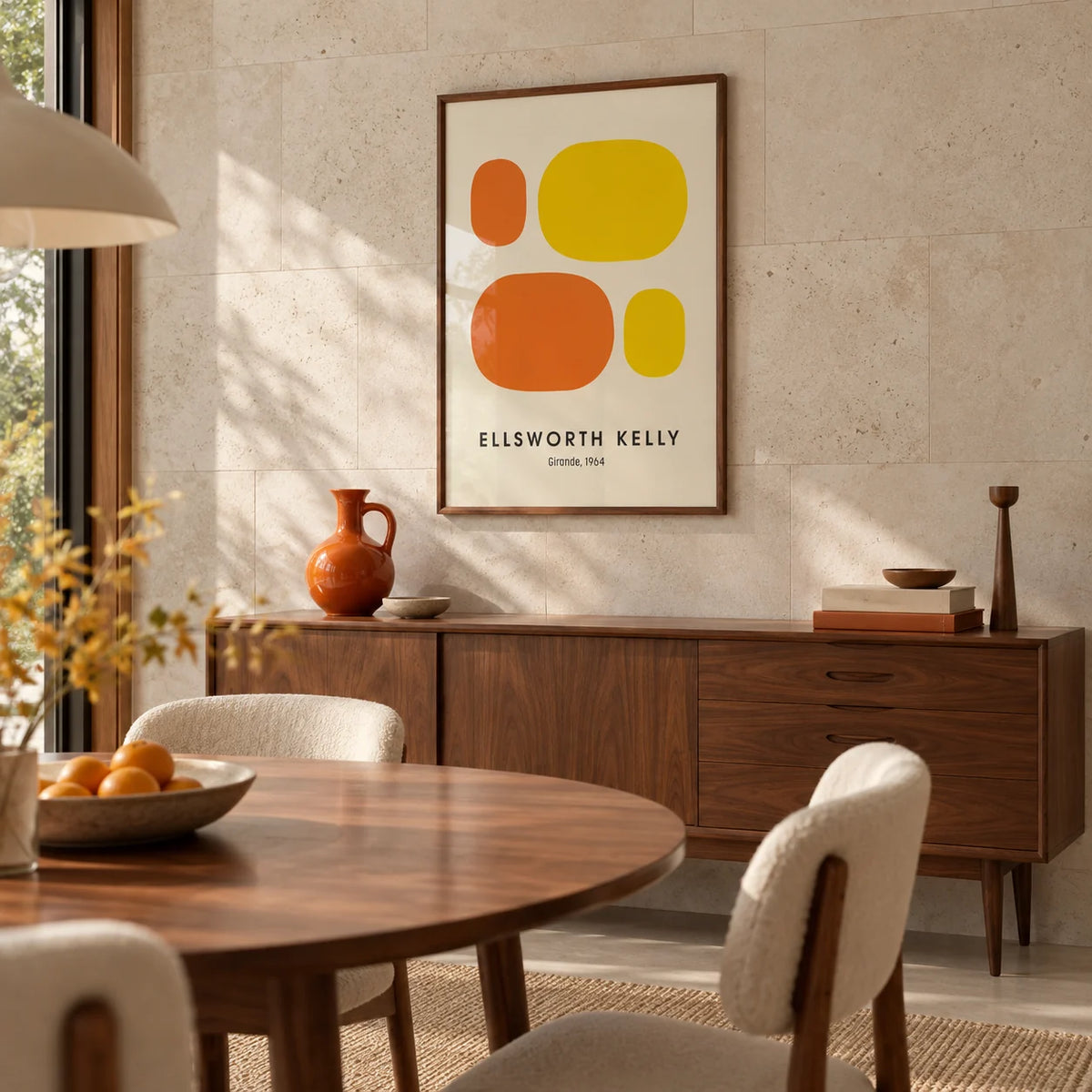 Ellsworth Kelly Prints, framed on the wall of a mid-century dining room with a pale stone wall