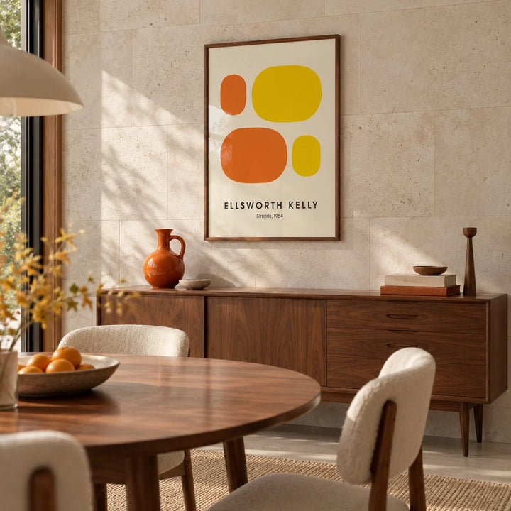 Ellsworth Kelly Prints, framed on the wall of a mid-century dining room with a pale stone wall