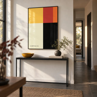 Ellsworth Kelly Poster, framed on the wall of a modern hallway with a white wall and a dark grey floor
