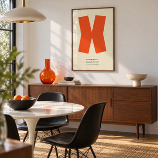 Ellsworth Kelly Print, framed on the wall of a mid-century modern dining room with a white wall
