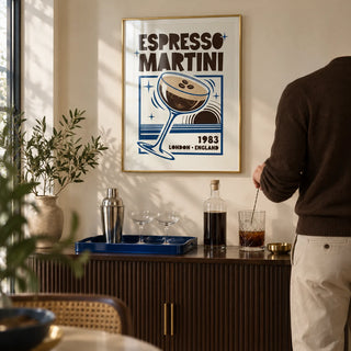 Espresso Martini Print, framed on the wall of a compact home bar alcove in a stylish UK flat with a cream wall and a dark brown fluted drinks cabinet in a living room