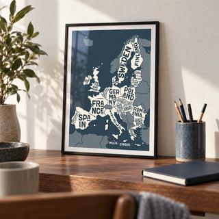 Europe Map Print, a small A4 framed print leaning on a walnut writing desk