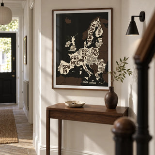 Europe Poster, framed on the wall of a narrow entrance hallway in a renovated UK terrace with chalk white walls and a plain stone floor