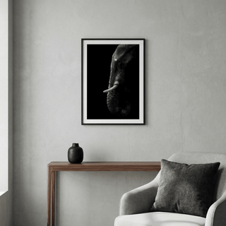 Curved tusk elephant photo print displayed above a modern sofa