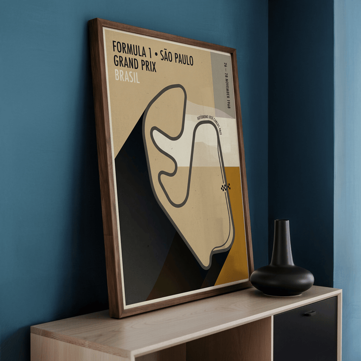Framed Sao Paulo Race Circuit Diagram Poster leaning on a wooden surface beside a black vase