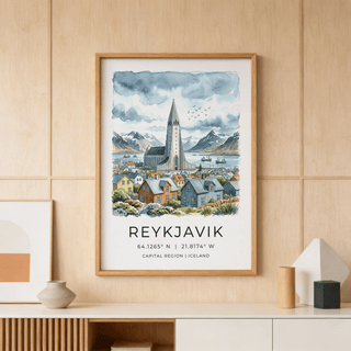 Clustered Icelandic houses and landmark church spire beside a calm bay at sunrise