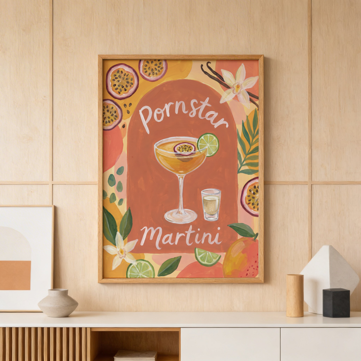 Showcasing a cocktail poster print with a coupe glass, lime wheel garnish, and passion fruit halves around the border