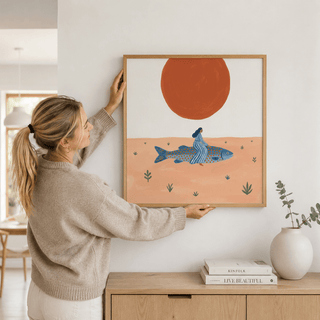 Graphic poster print of a large fish crossing a sandy scene with small plants