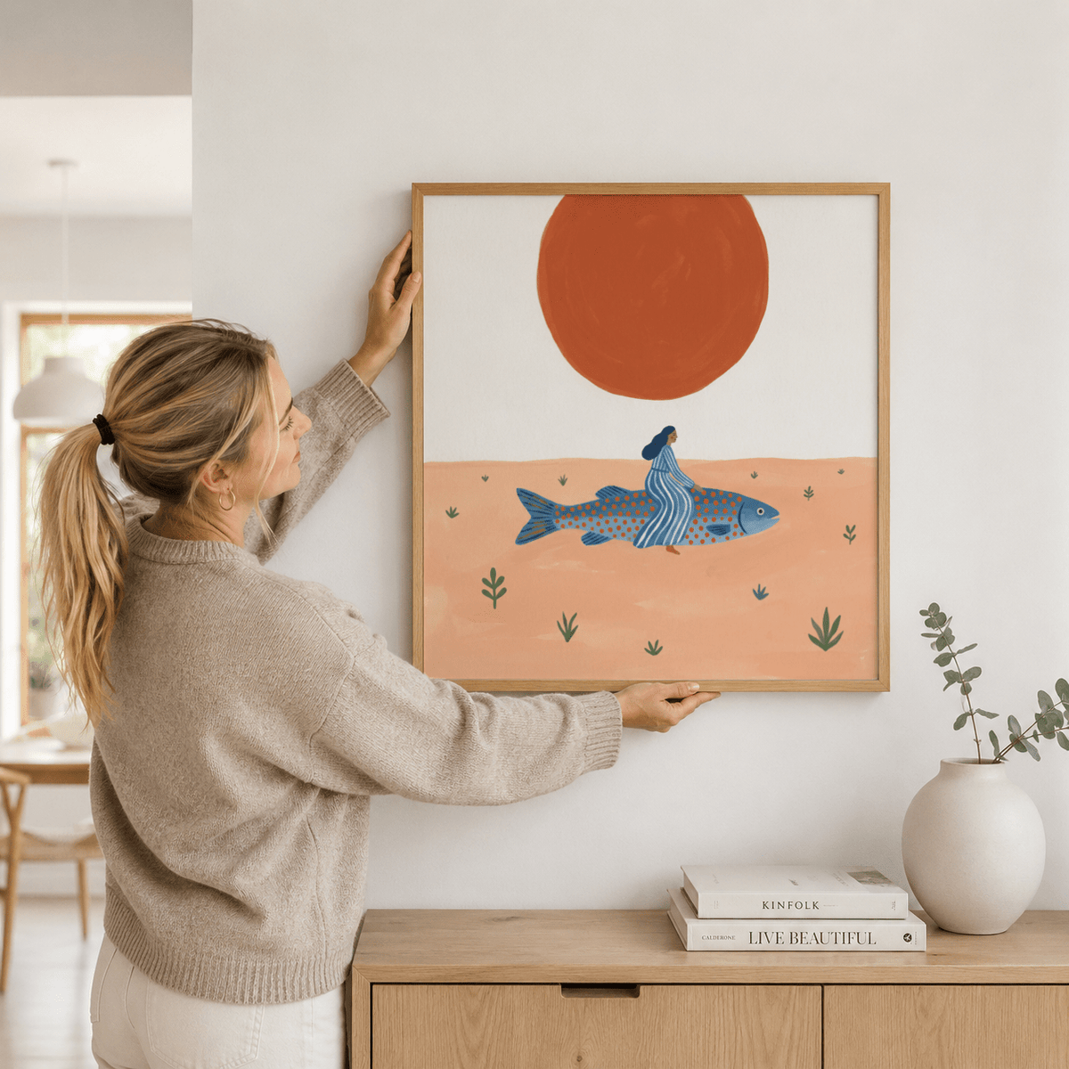 Graphic poster print of a large fish crossing a sandy scene with small plants