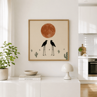 Modern desert wall decor depicting birds under a round moon with cactus silhouettes
