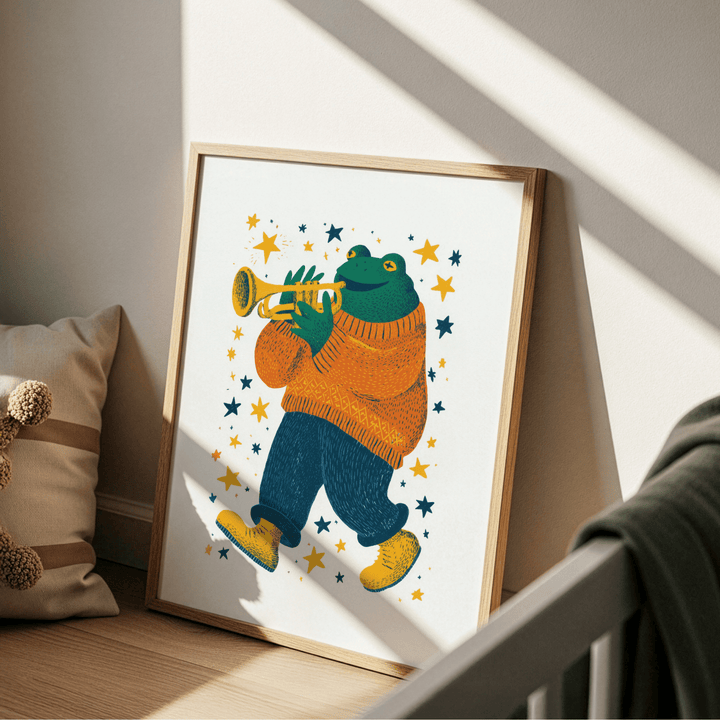 Print leaning on a floor next to a cushion with a frog playing trumpet in orange and blue