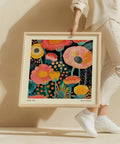 Colorful floral wall art with vibrant orange and yellow flowers.