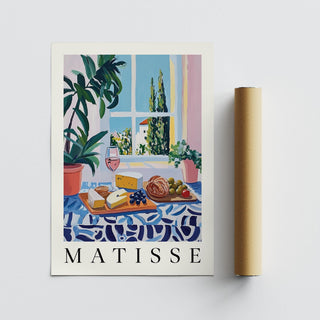 French prints with blue patterned tablecloth, bread, grapes, and tomatoes.