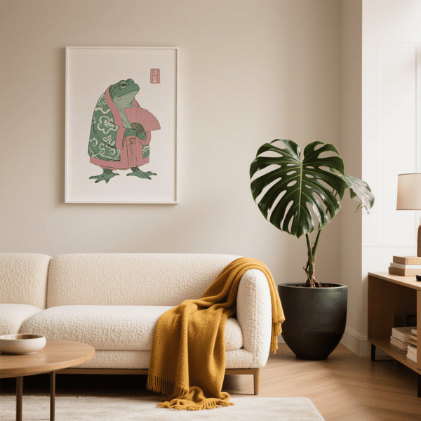 Living room with a white sofa, plant, and framed artwork on a beige wall.