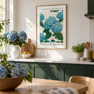Flower Market Prints, framed on the wall of a bright kitchen with plain deep green cabinets and a white worktop