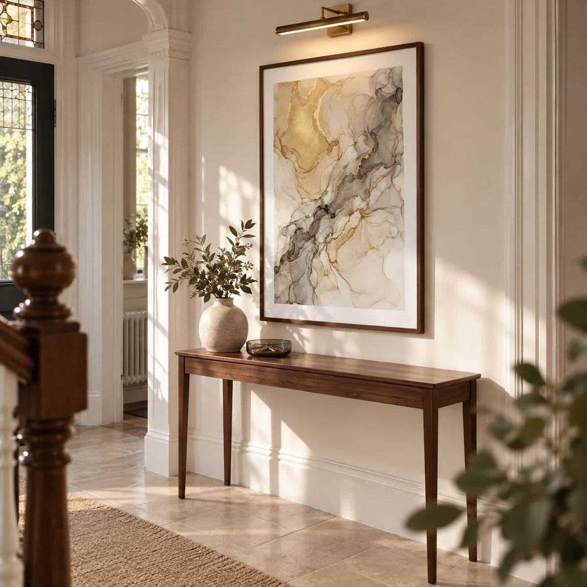 Fluid Art Gold Poster, framed on the wall of a welcoming hallway in a UK Victorian terrace updated with warm white walls and plain limestone floor tiles