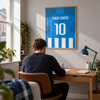 Football Shirt Poster in Blue and White Stripes with Blue Sleeves, framed on the wall of a bright home study for a young adult football fan (22-35) in a UK terrace with a soft grey wall