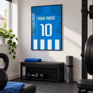 Football Shirt Poster in Blue and White Stripes with Blue Sleeves, framed on the wall of a small home gym in a converted UK spare room with white walls and a plain dark rubber floor