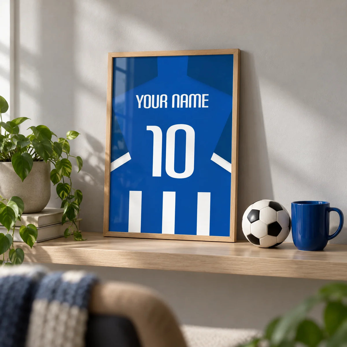 Football Shirt Poster in Blue and White Stripes with White Number, a small A4 framed print leaning on a pale oak shelf in a living room